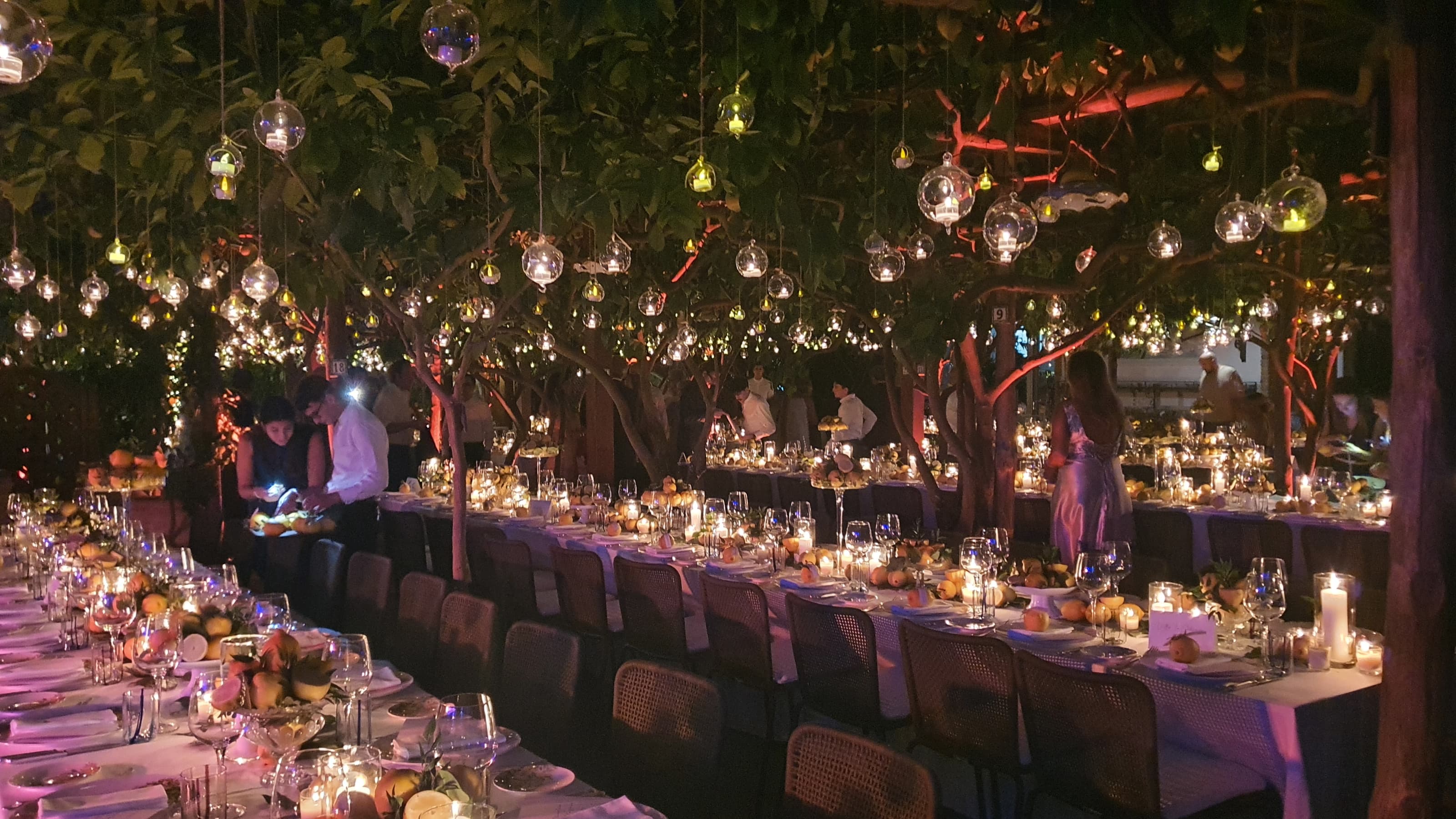Paolino gala night under lemon trees with hanging candle globes and long dinner tables in Capri